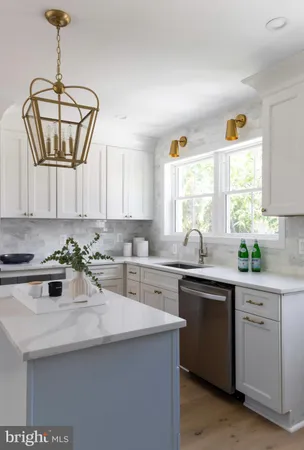 a kitchen with a sink a window stainless steel appliances and cabinets
