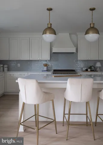 a kitchen with stainless steel appliances granite countertop a sink a stove a table and chairs