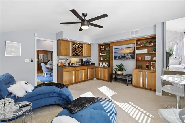 a bed sitting in a spacious bedroom next to a window