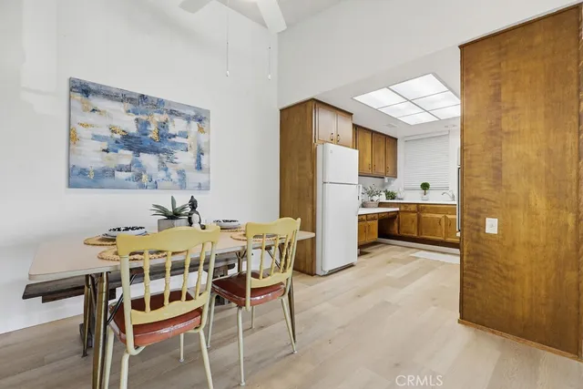 a view of a dining room with furniture and a kitchen