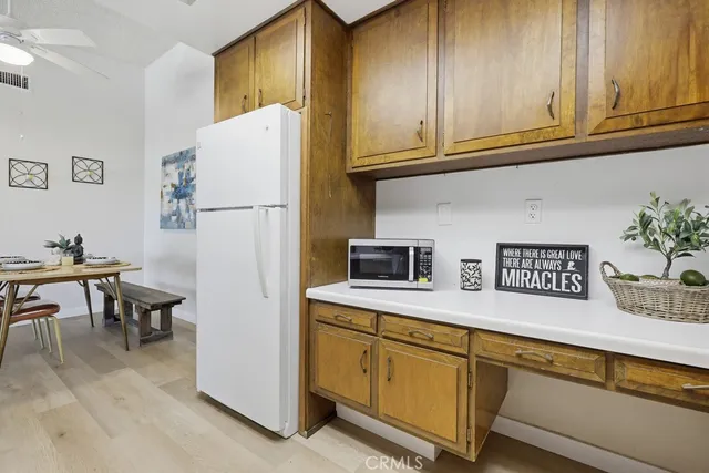 a kitchen with stainless steel appliances granite countertop a refrigerator and a stove top oven