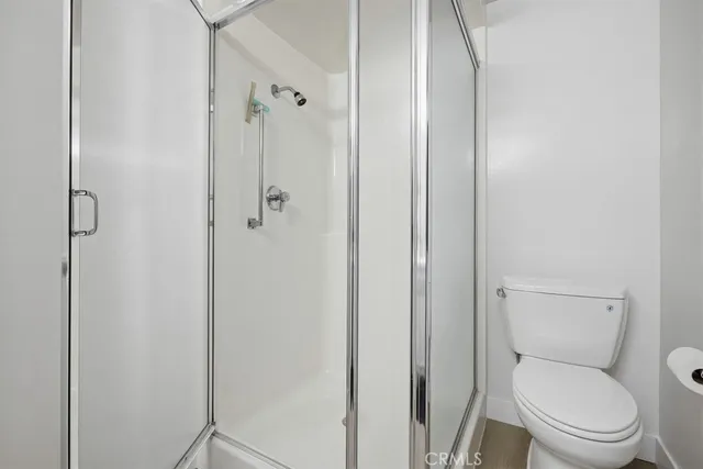 a white toilet next to a bathroom