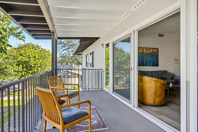 a view of porch with a table and chairs