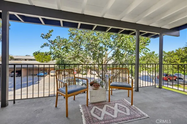 a view of staircase with two chair and a potted plant
