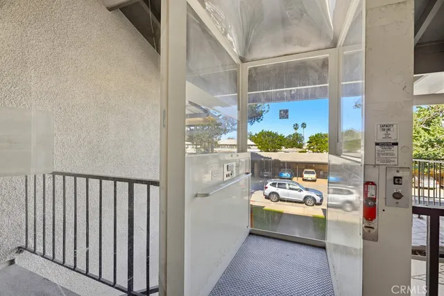 a utility room with stainless steel appliances a refrigerator and a window