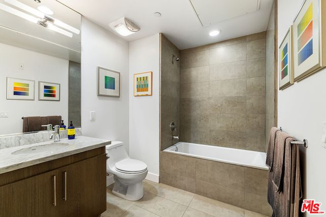 a bathroom with a double vanity sink toilet and shower
