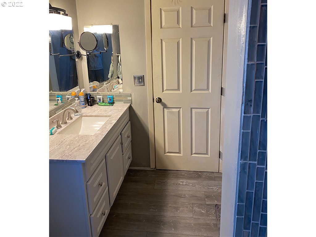 724 Southeast 3rd Street Pendleton, OR 97801 - Photo 2 of 8 a bathroom with granite countertop a sink and a mirror