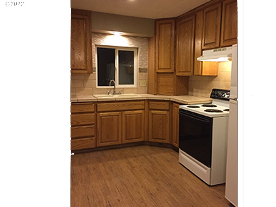 724 Southeast 3rd Street Pendleton, OR 97801 - Photo 3 of 8 a kitchen with stainless steel appliances granite countertop a stove and a sink
