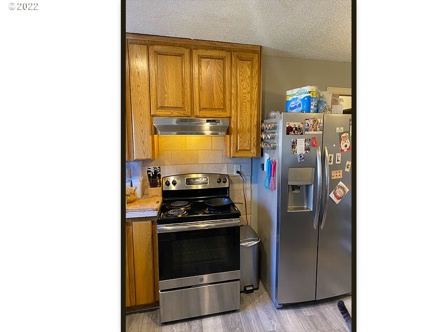 724 Southeast 3rd Street Pendleton, OR 97801 - Photo 8 of 8 a kitchen with stainless steel appliances a stove and a refrigerator