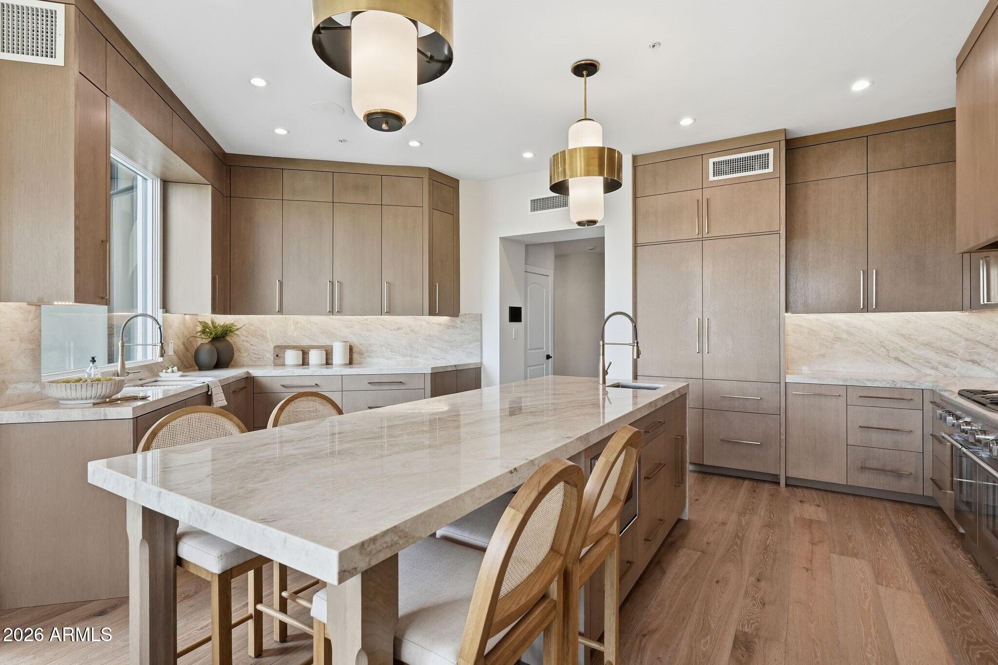 7475 East Gainey Ranch Road, Unit 7 Scottsdale, AZ 85258 - Photo 28 of 77 a kitchen with granite countertop a sink cabinets and stainless steel appliances