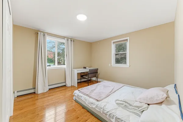 a bedroom with a bed and a window