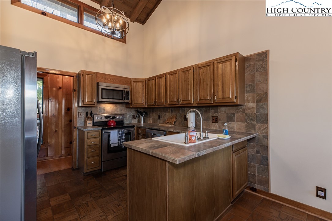 107 Buckshot Ridge Road Deep Gap, NC 28618 - Photo 16 of 30 a kitchen with a sink cabinets and stainless steel appliances