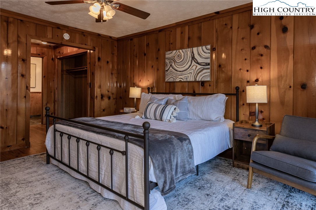 107 Buckshot Ridge Road Deep Gap, NC 28618 - Photo 20 of 30 a bedroom with a bed and a chandelier