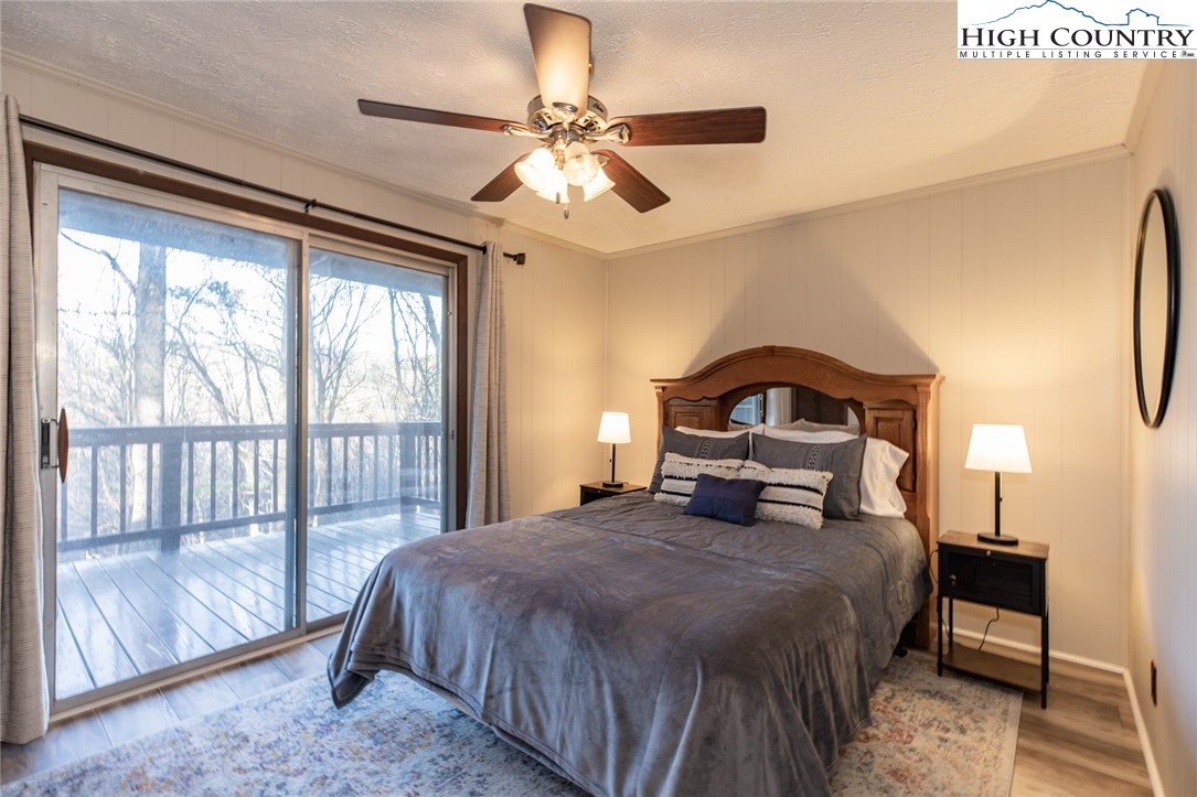 107 Buckshot Ridge Road Deep Gap, NC 28618 - Photo 26 of 30 a bedroom with a bed next to a large window with a balcony view