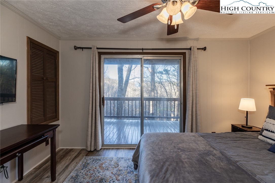 107 Buckshot Ridge Road Deep Gap, NC 28618 - Photo 27 of 30 a bedroom with a bed and a window