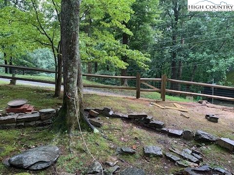 107 Buckshot Ridge Road Deep Gap, NC 28618 - Photo 28 of 30 a view of a backyard with a tree