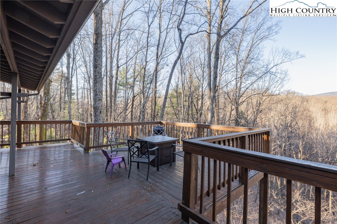 107 Buckshot Ridge Road Deep Gap, NC 28618 - Photo 6 of 30 a balcony with wooden floor and outdoor seating
