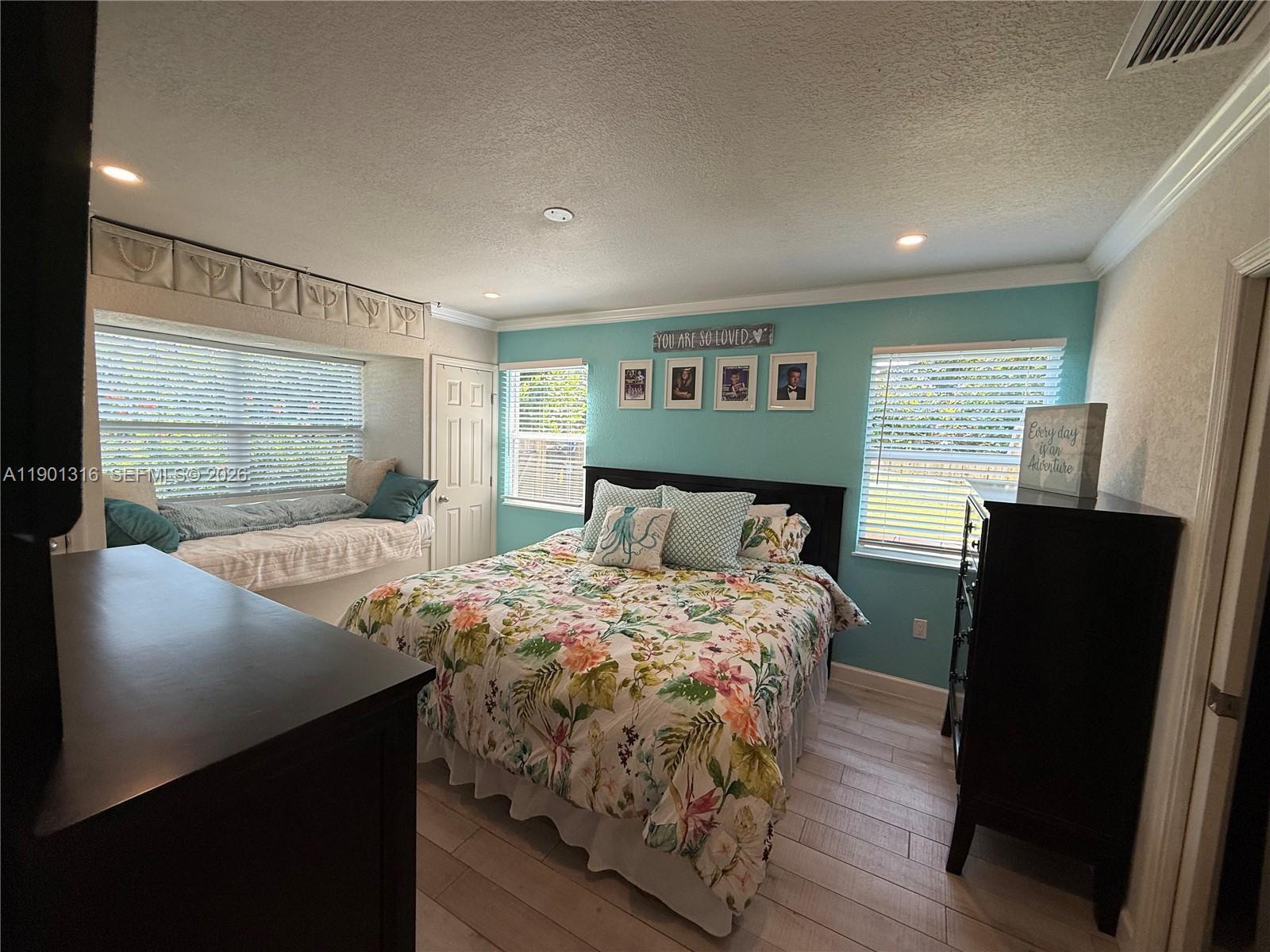 9546 Southwest Adams Avenue Okeechobee, FL 34974 - Photo 16 of 16 a bedroom with a bed and wooden floor