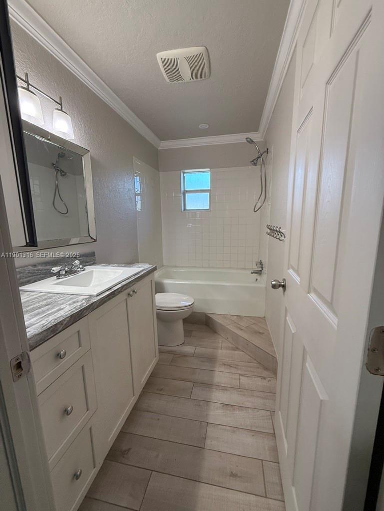 9546 Southwest Adams Avenue Okeechobee, FL 34974 - Photo 7 of 16 a bathroom with a granite countertop sink toilet and shower