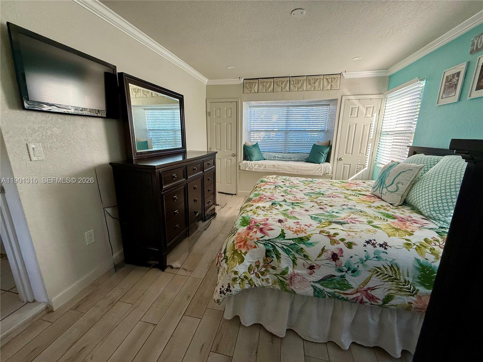 9546 Southwest Adams Avenue Okeechobee, FL 34974 - Photo 10 of 16 a bedroom with a bed and a flat screen tv