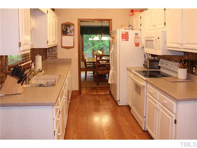 2025 Lovdal Drive Raleigh, NC 27613 - Photo 11 of 15 a kitchen that has a lot of cabinets in it