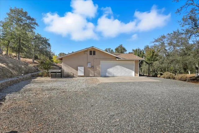 a view of a house with a yard and garage