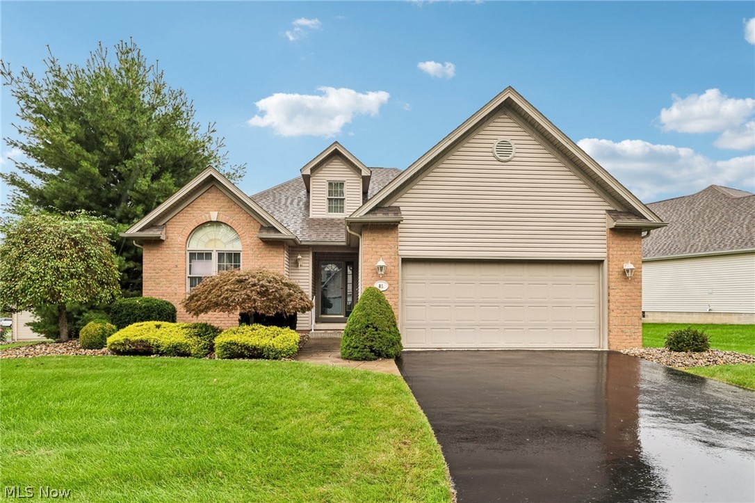 7007 Clingan Road, Unit 85 Youngstown, OH 44514 - Photo 1 of 46 Brick and siding exterior with an attached two-car garage, arched front window, and mature landscaping
