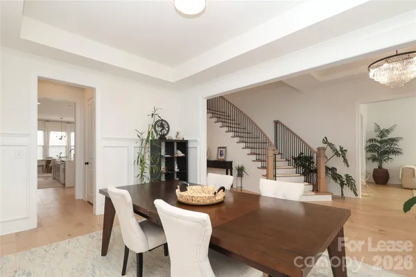a dining room with furniture and wooden floor