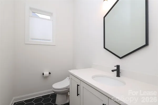 a bathroom with a sink toilet and mirror