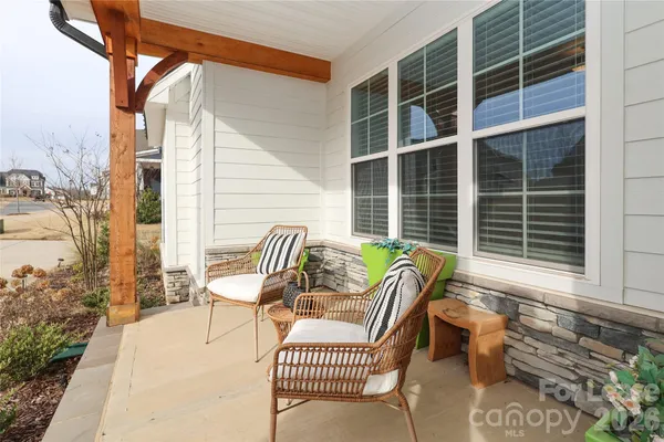 a balcony with furniture and a potted plant