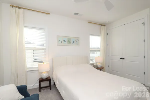 a bedroom with a bed and dresser