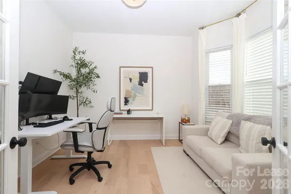 a view of a livingroom with workspace and a couch