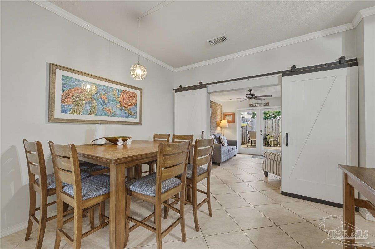 26063 Canal Road, Unit 3F Orange Beach, AL 36561 - Photo 24 of 72 a view of a dining room with furniture and a chandelier