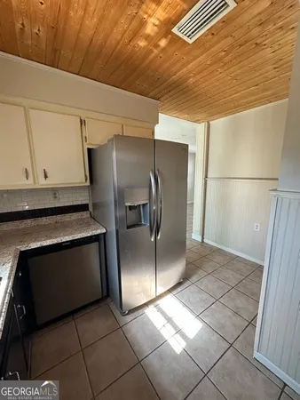 a view of a refrigerator in kitchen and wooden floor