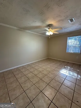 a view of a livingroom with a ceiling fan and window