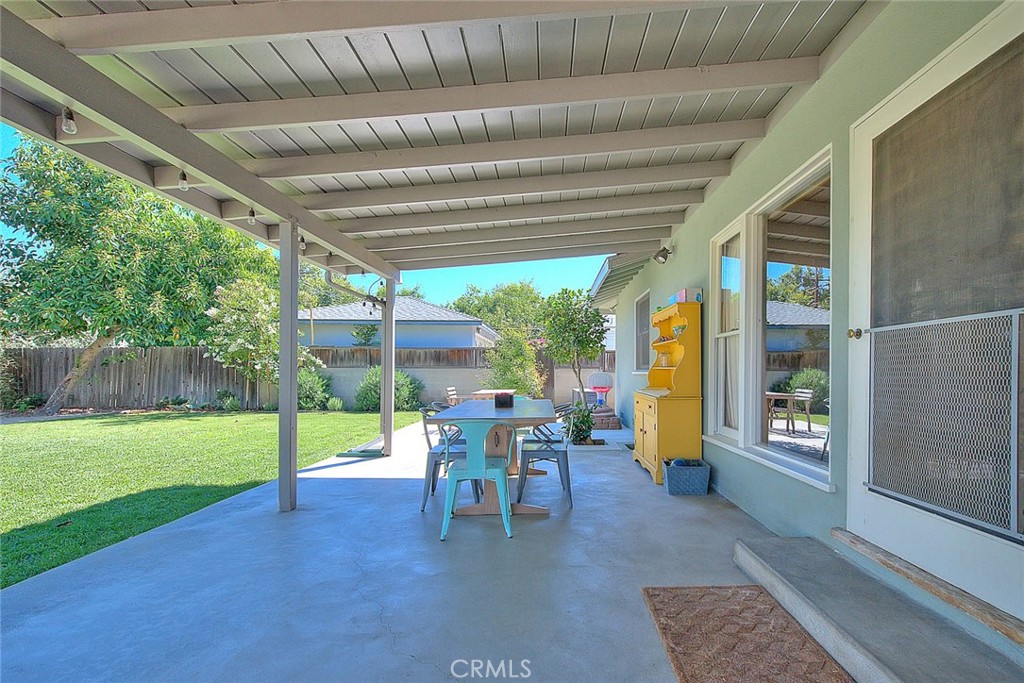 4845 Granada Avenue Riverside, CA 92504 - Photo 15 of 56 a view of a patio with table and chairs potted plants with wooden floor