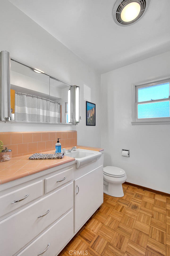 4845 Granada Avenue Riverside, CA 92504 - Photo 20 of 56 a bathroom with a granite countertop sink and a mirror