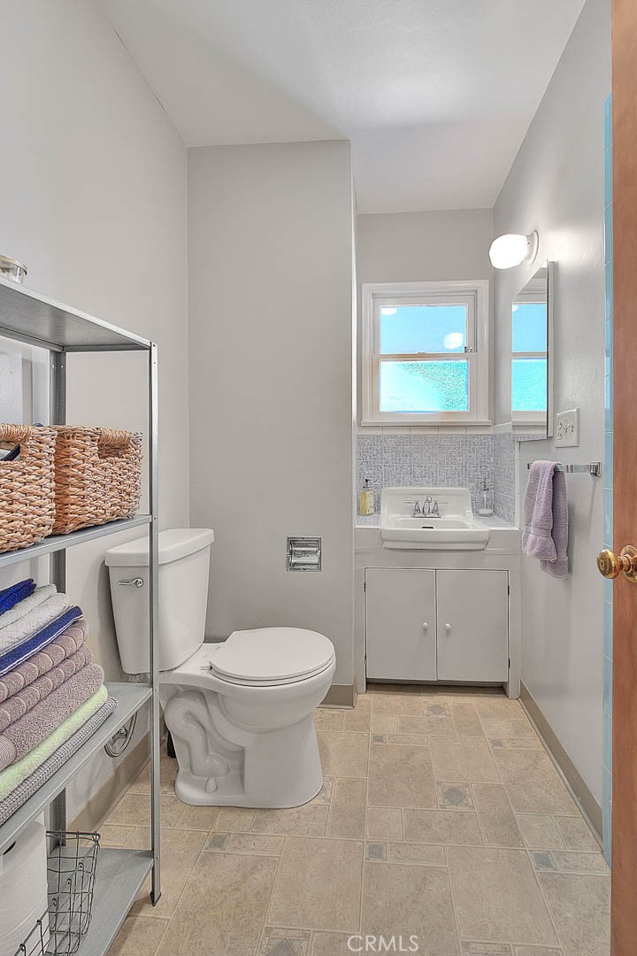 4845 Granada Avenue Riverside, CA 92504 - Photo 23 of 56 a bathroom with a sink toilet and mirror