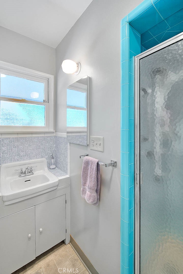 4845 Granada Avenue Riverside, CA 92504 - Photo 24 of 56 a bathroom with a sink vanity and mirror