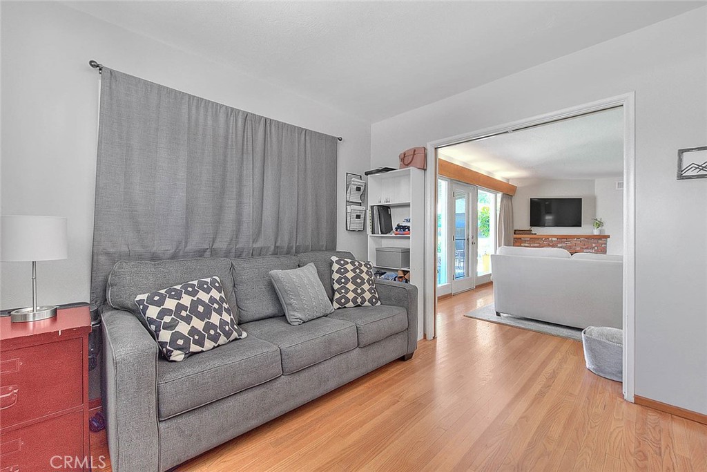 4845 Granada Avenue Riverside, CA 92504 - Photo 34 of 56 a living room with furniture and a large mirror with wooden floor