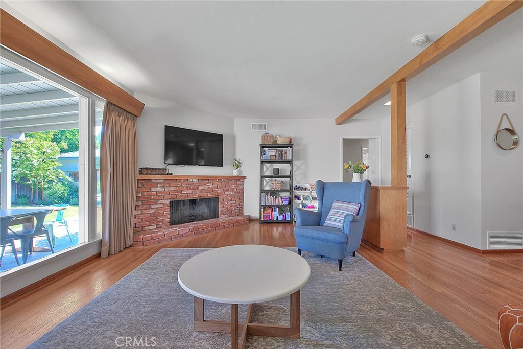 4845 Granada Avenue Riverside, CA 92504 - Photo 46 of 56 a living room with furniture a fireplace and a flat screen tv