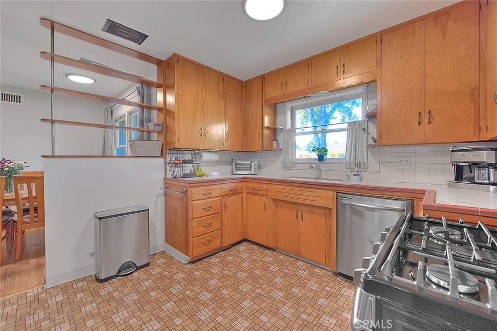 4845 Granada Avenue Riverside, CA 92504 - Photo 50 of 56 a kitchen with stainless steel appliances granite countertop a stove a sink and a refrigerator