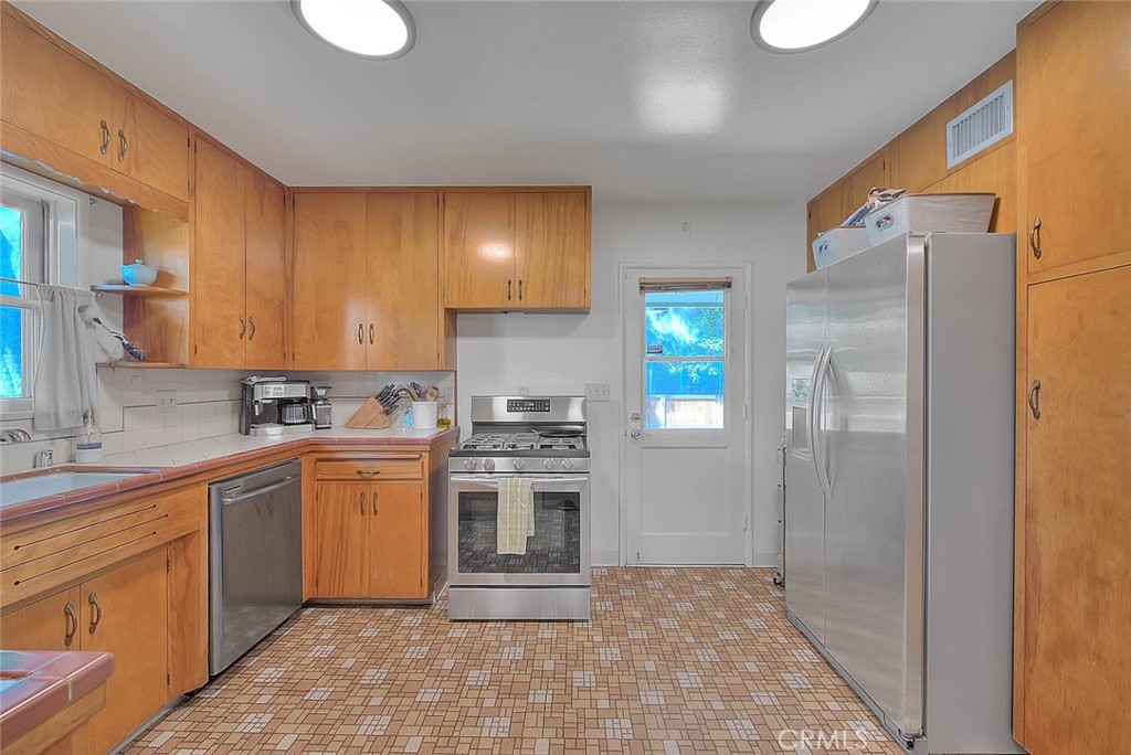 4845 Granada Avenue Riverside, CA 92504 - Photo 53 of 56 a kitchen with stainless steel appliances granite countertop a stove a sink and a refrigerator