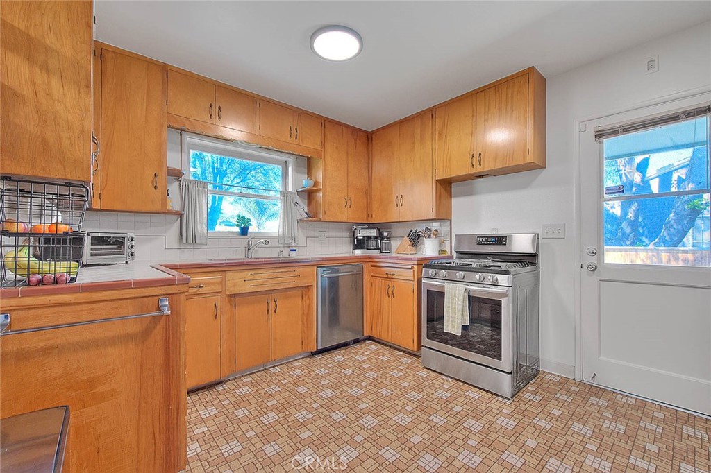 4845 Granada Avenue Riverside, CA 92504 - Photo 54 of 56 a kitchen with stainless steel appliances granite countertop a stove a sink and a microwave