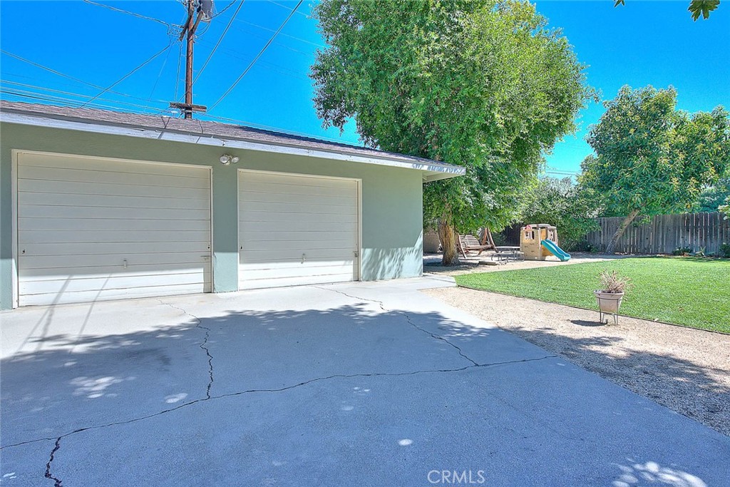 4845 Granada Avenue Riverside, CA 92504 - Photo 55 of 56 a view of a house with a yard and garage