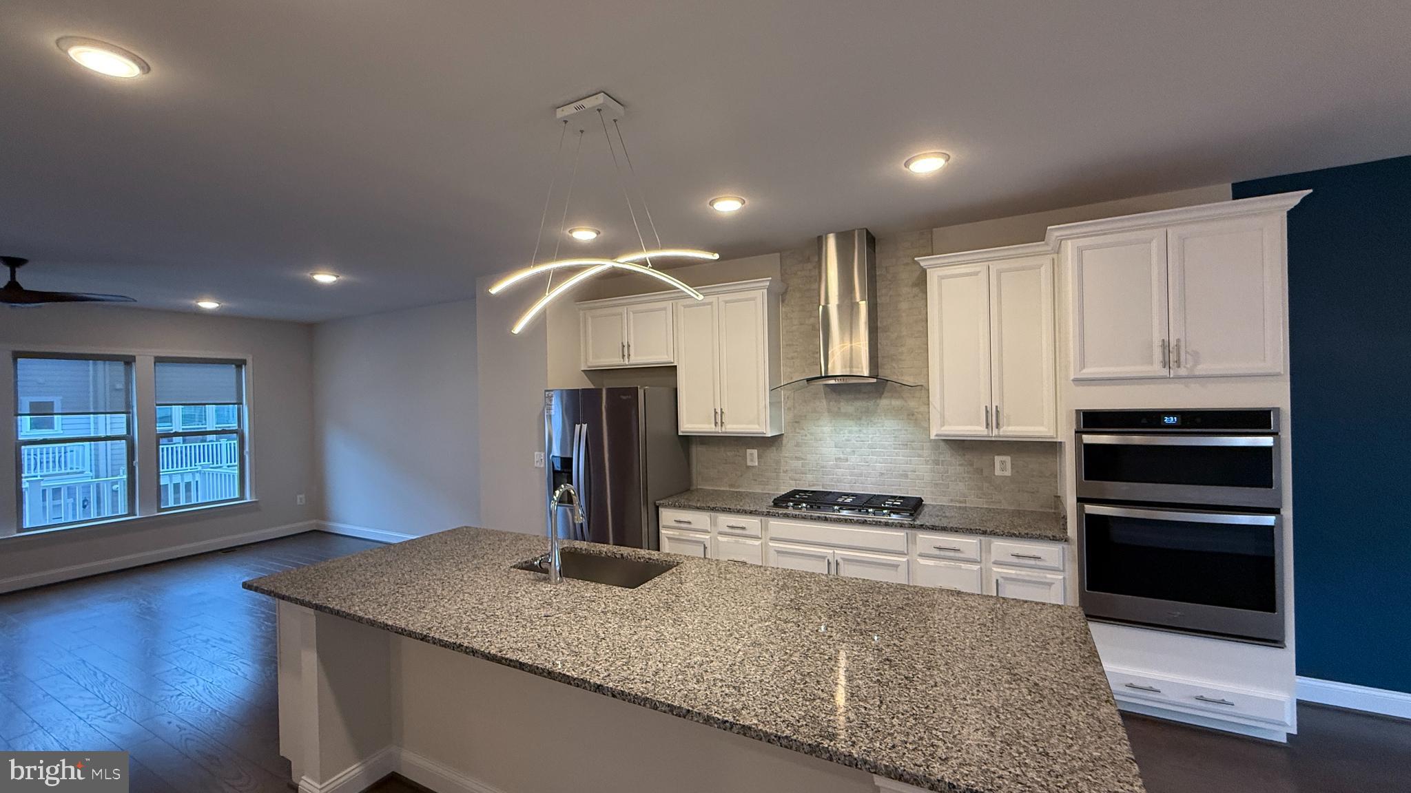 1949 Greenbriar Hall Road Dumfries, VA 22026 - Photo 4 of 26 a kitchen with stainless steel appliances granite countertop a sink stove and refrigerator