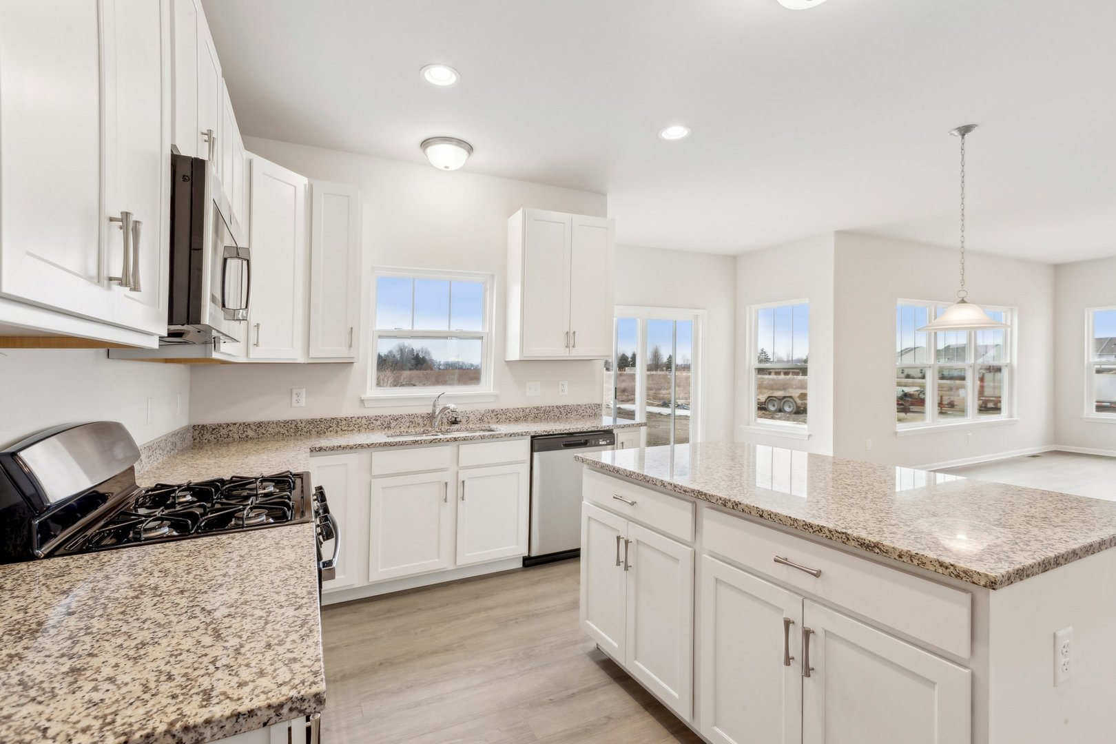 737 Cherry Circle Elburn, IL 60119 - Photo 19 of 50 a kitchen with stainless steel appliances granite countertop a stove a sink and a white cabinets