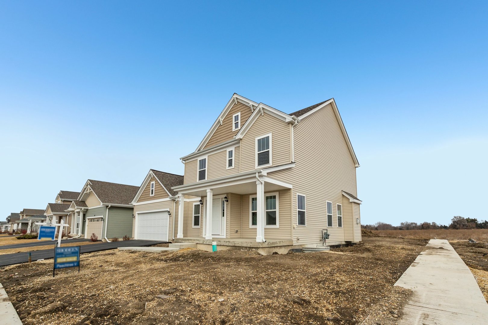 737 Cherry Circle Elburn, IL 60119 - Photo 3 of 50 a view of a white house with a large windows next to a road