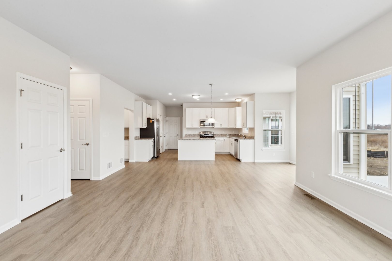 737 Cherry Circle Elburn, IL 60119 - Photo 10 of 50 a view of a kitchen with wooden floor and windows