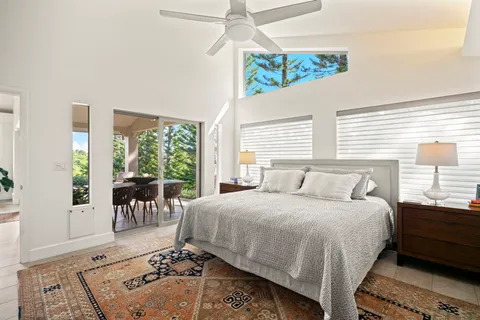 a living room with a bed furniture and a large window